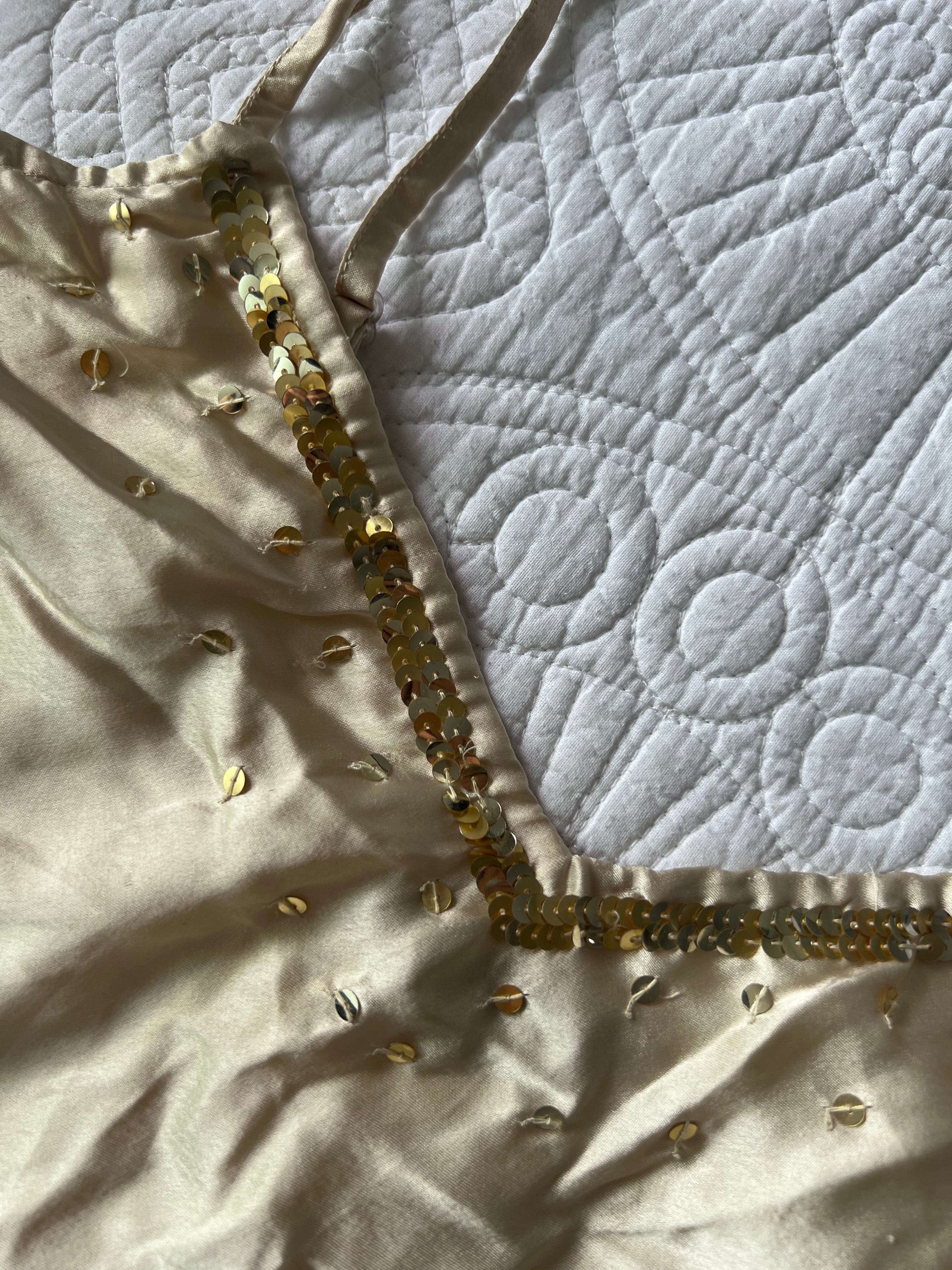 Cream Satin like top with spaghetti straps and gold sequences
