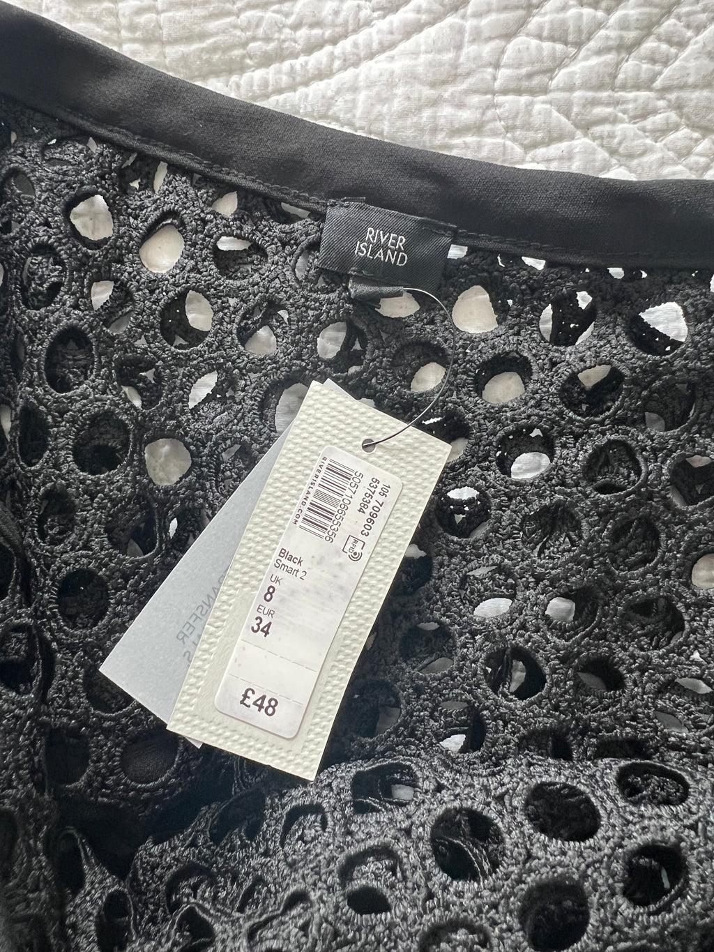 Asymmetrical black top with holes