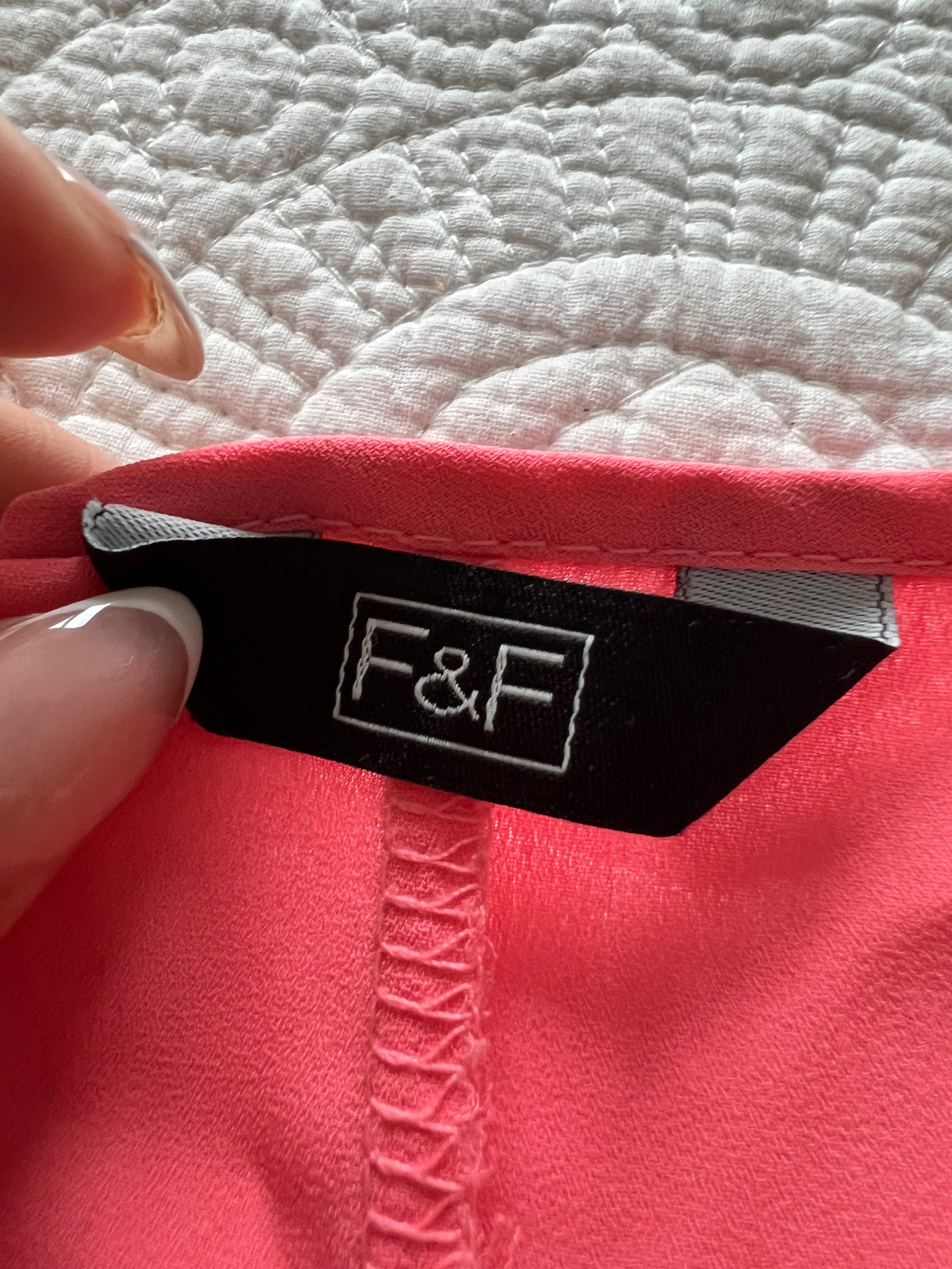 Pink flowy vest with long, cut out back
