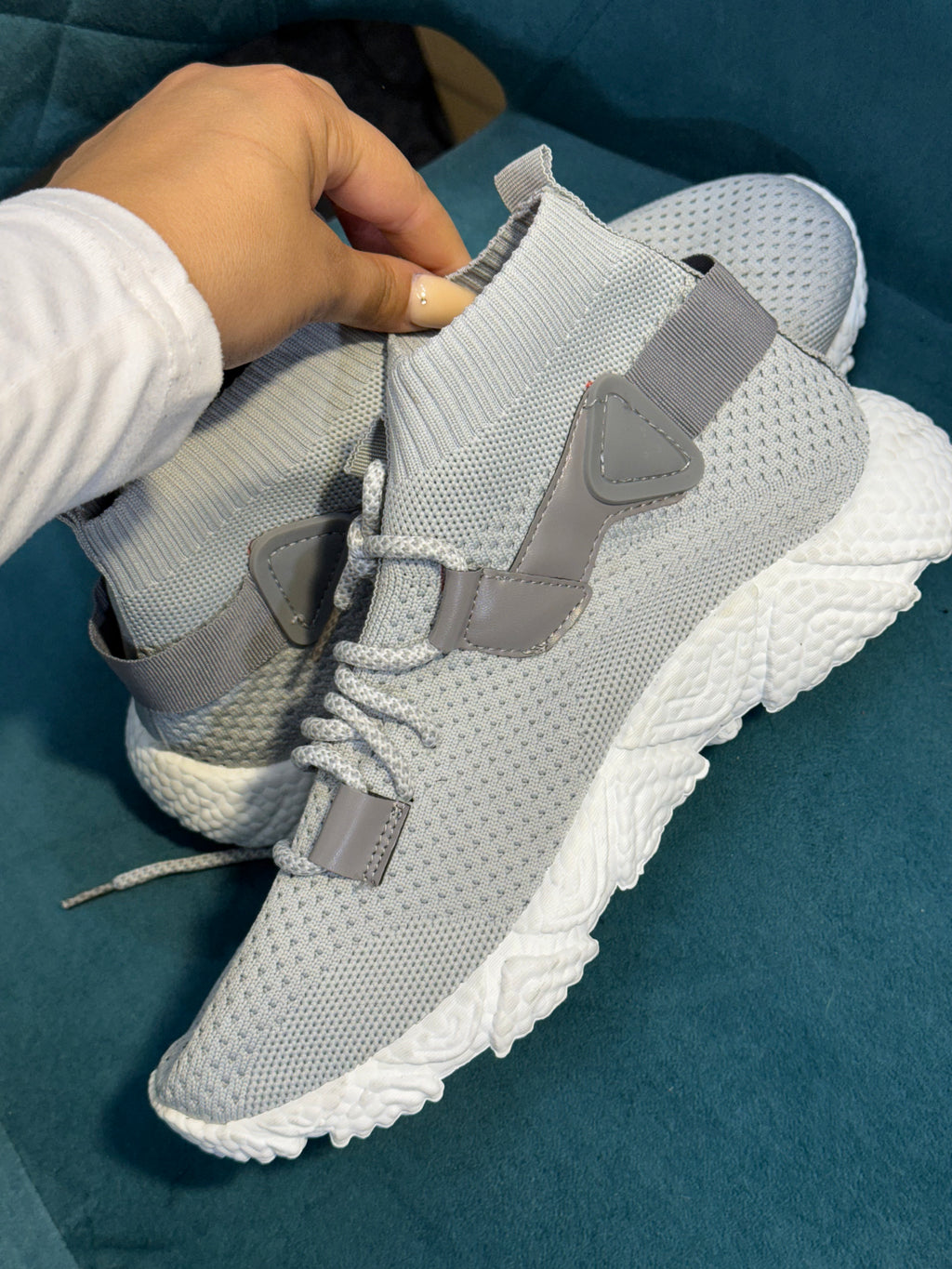 Grey trainers with white sole