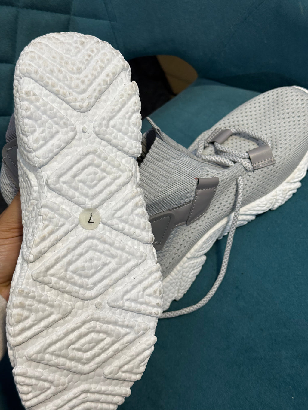 Grey trainers with white sole