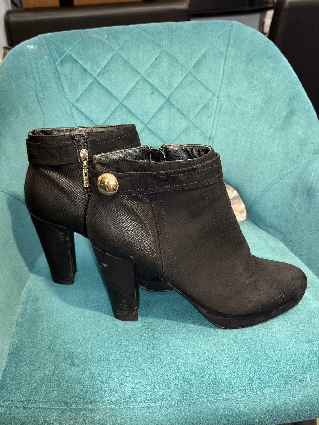 Women’s black heeled ankle boots with gold button detail
