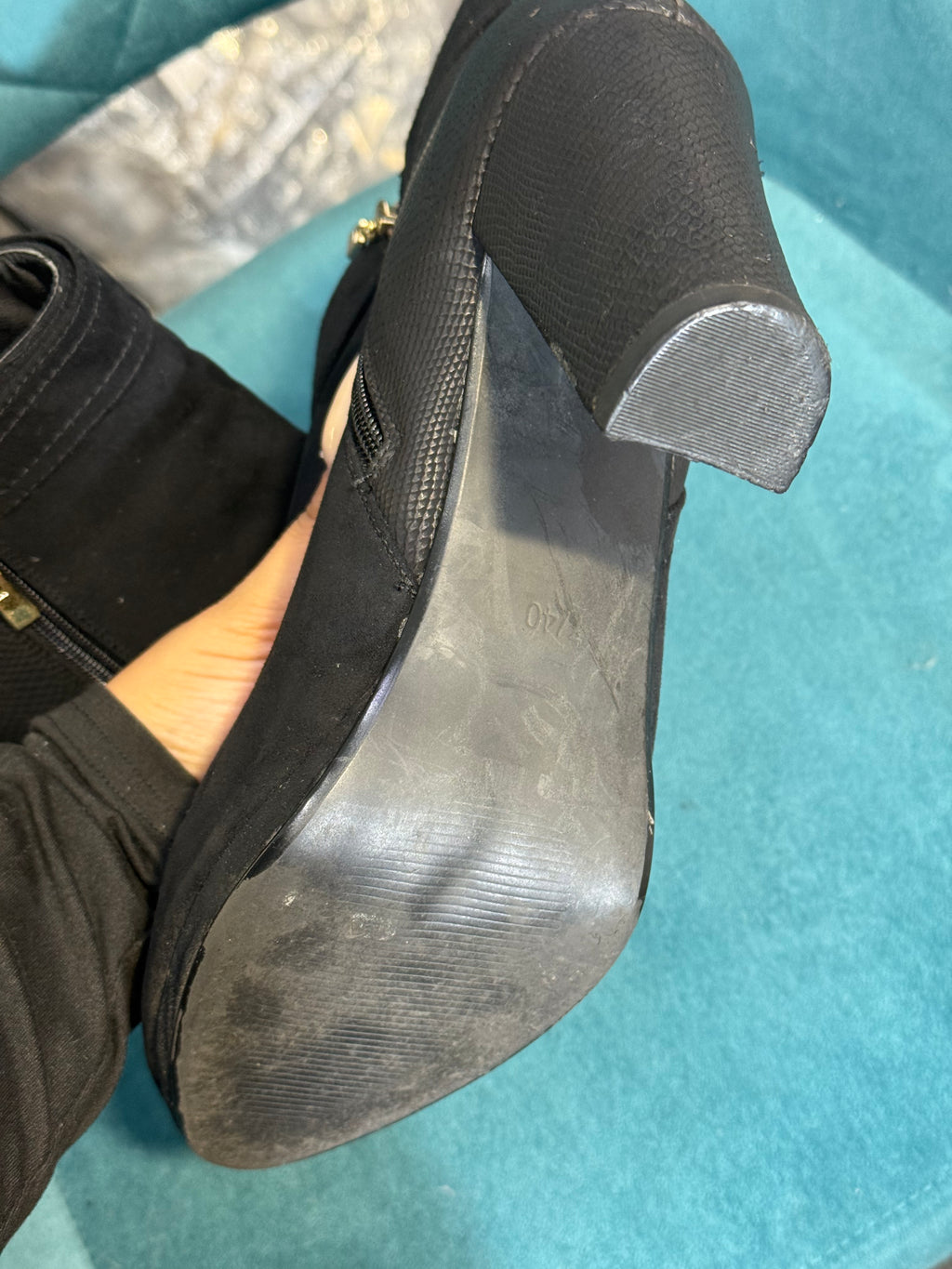 Women’s black heeled ankle boots with gold button detail