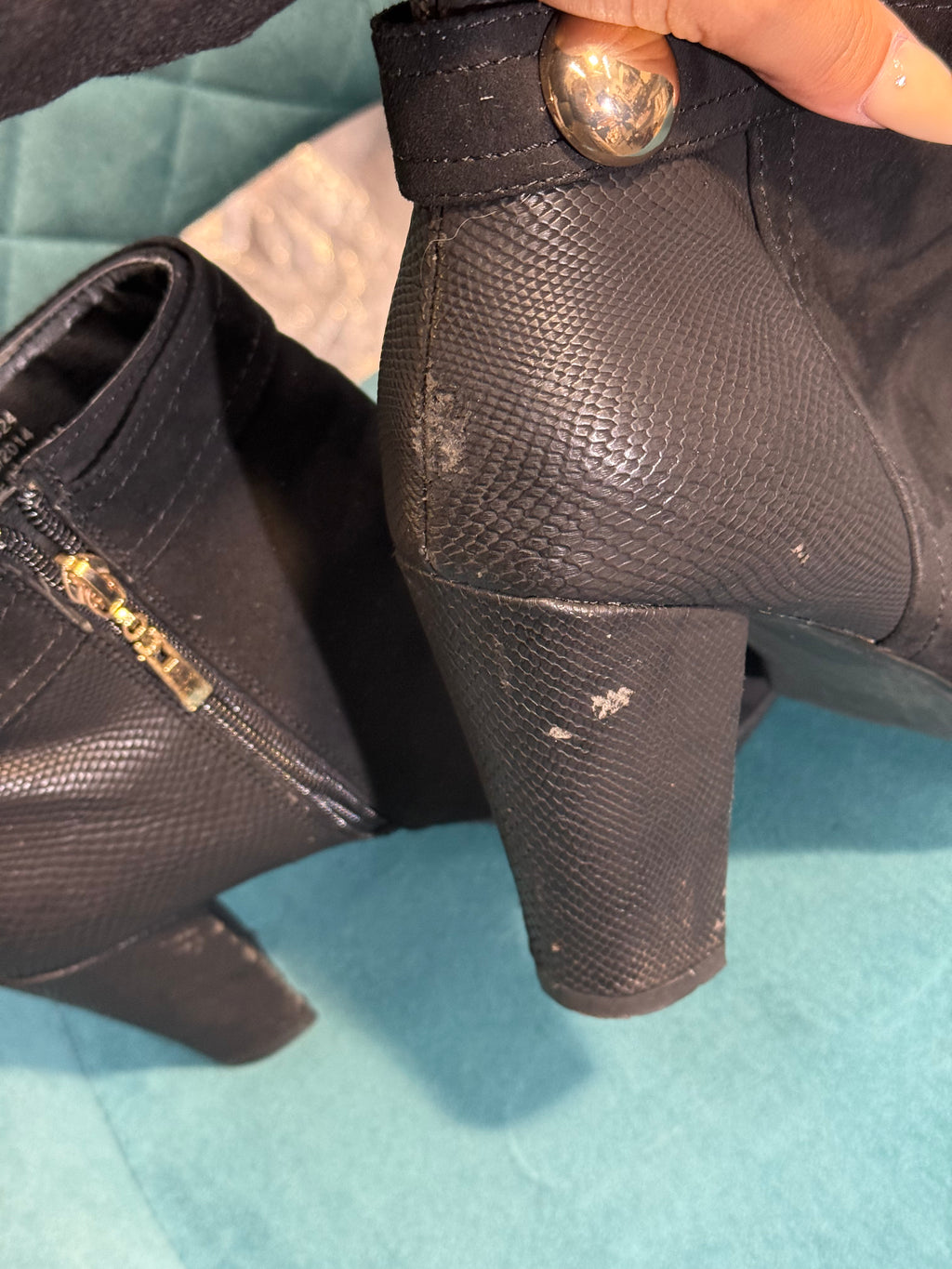 Women’s black heeled ankle boots with gold button detail