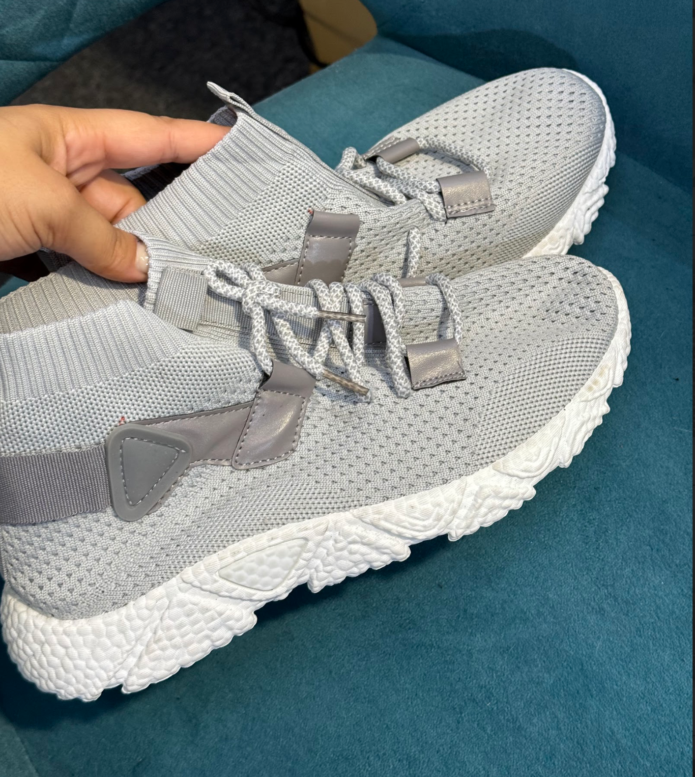 Grey trainers with white sole