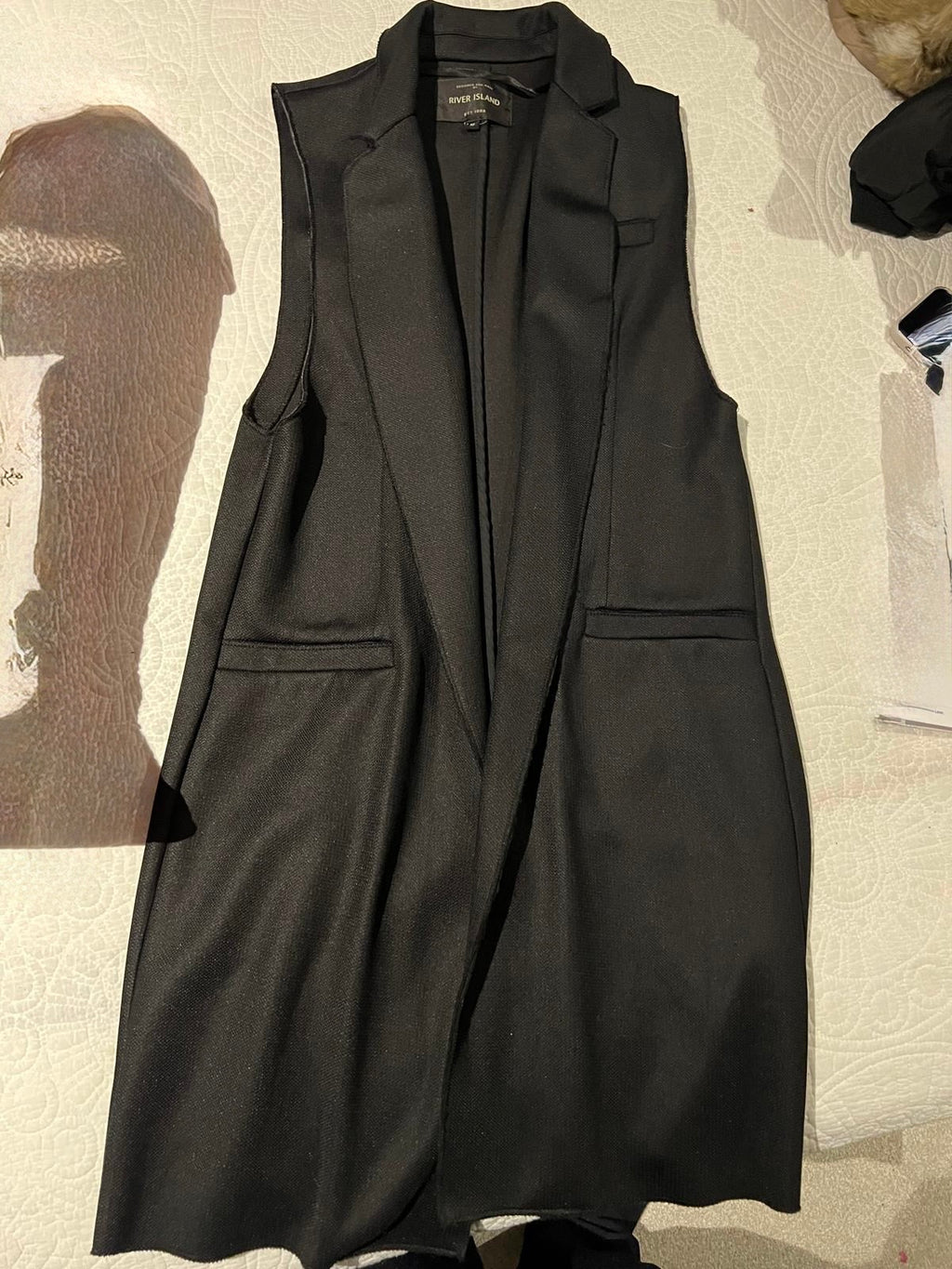 Black, long, sleeveless blazer